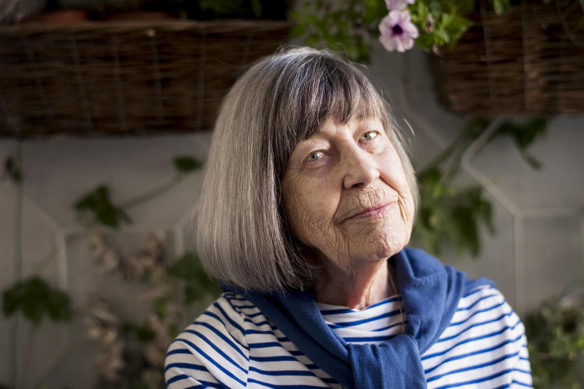 Portrait of smiling mature woman in empty room stock photo